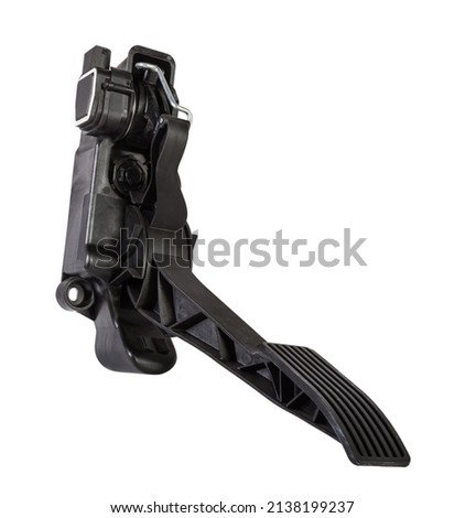 Floor gas pedal on a white isolated background in a photo studio for sale in a car service. Black auto part for replacement during repair in the workshop. Spare part junkyard.