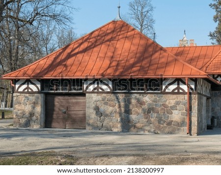 picture of an old stone house with a red roof