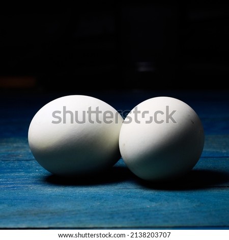 Two salted eggs on a wooden board.