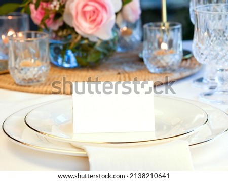 Mockup white blank space card, for Name place, Folded, greeting, invitation on wedding table setting background. with clipping path Royalty-Free Stock Photo #2138210641