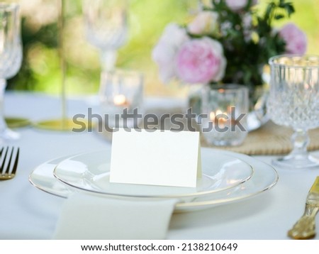 Mockup white blank space card, for Name place, Folded, greeting, invitation on wedding table setting background. with clipping path Royalty-Free Stock Photo #2138210649
