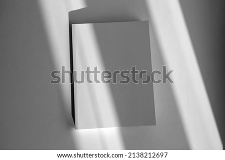Mockup of brochure with fold. Blank mock up of booklet, menu and book. White paper of magazine. Mockup of leaflet. Template of twofold pamphlet isolated on white background with shadows. Royalty-Free Stock Photo #2138212697