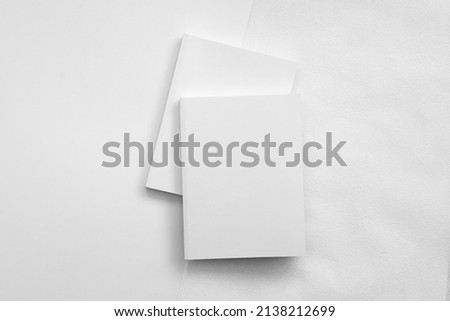 Mockup of brochure with fold. Blank mock up of booklet, menu and book. White paper of magazine. Mockup of leaflet. Template of twofold pamphlet isolated on white background Royalty-Free Stock Photo #2138212699