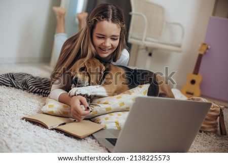 Teenage girl with a laptop in her room. High quality photo