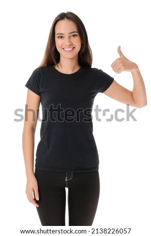 Pretty young woman in stylish t-shirt showing thumb-up on white background