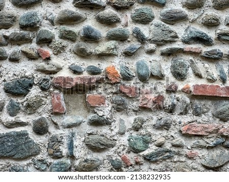 old stone romanic medieval wall and brick pattern background in sunny day. High quality photo