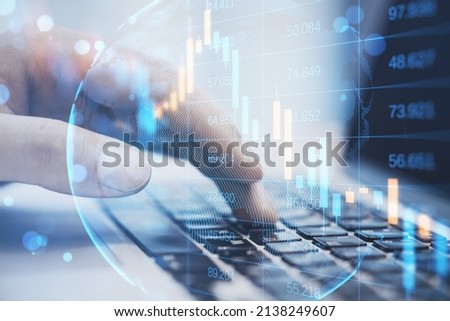 Close up of male hand using laptop keyboard with abstract falling candlestick forex chart on blurry background. Crisis, workplace and stock concept. Double exposure Royalty-Free Stock Photo #2138249607