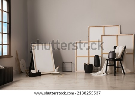 Stylish artist's studio interior with canvas and brushes Royalty-Free Stock Photo #2138255537