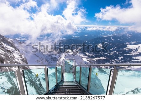 Spectacular alpine view with the Stairscase to Nowhere on the snowy Dachstein summit, Schladming, Styria, Austria. Pure thrill combined with a magnificent view. Royalty-Free Stock Photo #2138267577