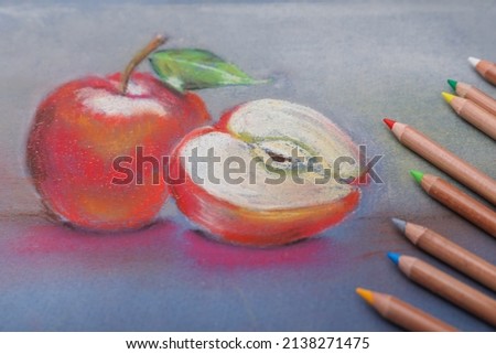 Beautiful drawing of apples and color pencils, closeup