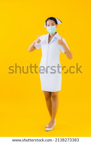 Portrait beautiful young asian woman thai nurse wear mask for protect covid19 or coronavirus and show alcohol gel on yellow isolated background