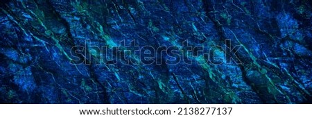 Toned stone texture. It looks like a marble surface. Navy blue background with copy space for design. Wide banner. Panoramic.
