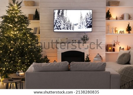 Cozy living room interior with beautiful Christmas tree and fireplace