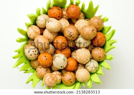 Japanese Rice Nuts "Dragon eggs". Ester desert. Idea for food decoration. Natural color balls with sesame seeds.