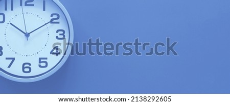 Clock on a purple background, the concept of time management, time planning. Web banner, free space.
