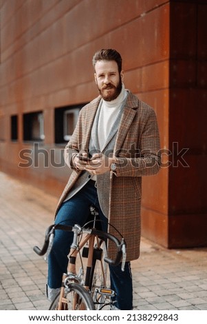 Creative Business Manager on the bike looking to the camera. Vertical image