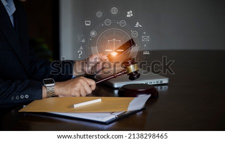 Law and Legal services concept, selective focus of Lawyer hands working with law interface icons at the table office.