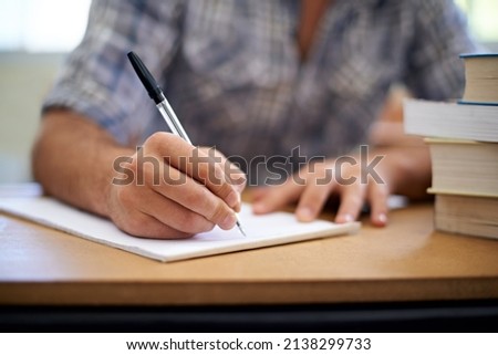 College takes dedication. A cropped shot of a young man making notes while studying. Royalty-Free Stock Photo #2138299733