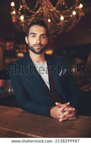 Waiting for my drink.... Cropped portrait of a young man sitting in a bar. Royalty-Free Stock Photo #2138299987