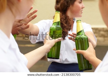 No. Young female student turning down alcohol in response to peer pressure. Royalty-Free Stock Photo #2138300705