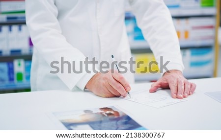 Ill write it down for you. Cropped shot of an unrecognizable pharmacist on a page.
