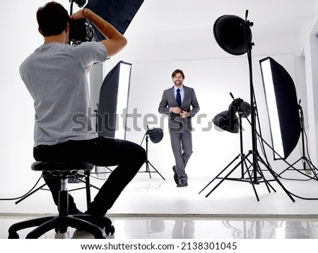 Composing a great portrait. Shot of a photographer working in his studio.