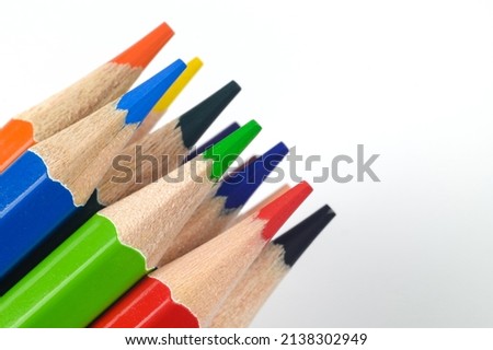A stack of sharp colored pencils for drawing on a white background.Layout of colored pencils for drawing. The concept of art and entertainment for children.Copy space.High quality photo