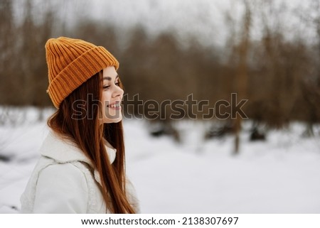 Happy young woman in winter clothes in a hat fun winter landscape winter holidays