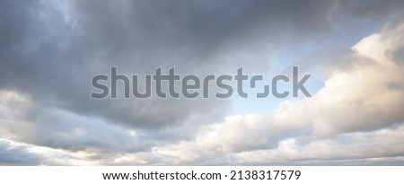 Ornamental clouds. Dramatic sky. Soft sunlight. Panoramic image, texture, background, graphic resources, design, copy space. Meteorology, heaven, hope, peace concept