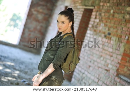 Beautiful woman in military clothes. Lara Croft style