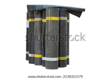 Rolls of new black roofing felt or bitumen. Group of rolls of bituminous waterproofing membrane isolated on white background. House renovation material   Royalty-Free Stock Photo #2138321579
