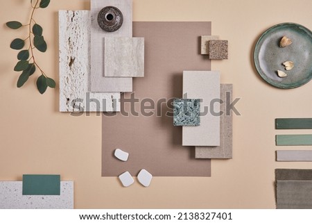 Creative flat lay composition of interior designer moodboard with textile and paint samples, panels and cement tiles. Beige, grey and green color palette. Copy space. Template.  Royalty-Free Stock Photo #2138327401