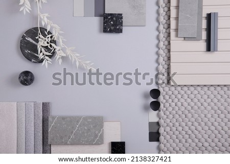 Elegant  flat lay composition in grey color palette with textile and paint samples, lamella panels and tiles. Architect and interior designer moodboard. Top view. Copy space. 