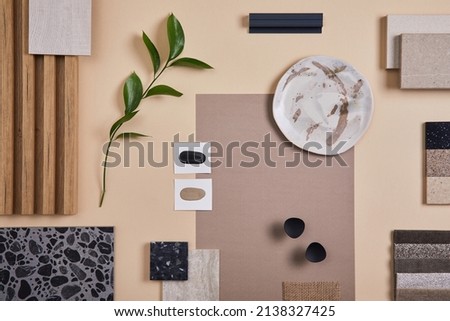 Creative flat lay composition of interior designer and architect moodboard. Textile and paint samples, lamella panels and lastrico tiles. Beige, black and green color palette. Copy space. Template. 