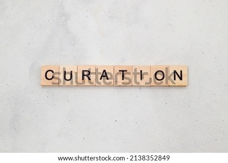 Top view of Curation word on wooden cube letter block on white background. Business concept