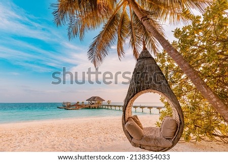 Tropical beach sunset as summer landscape with luxury resort beach palm swing hammock, sand seaside shore for sunset beach landscape. Tranquil beach horizon scenery vacation and summer holiday concept Royalty-Free Stock Photo #2138354033
