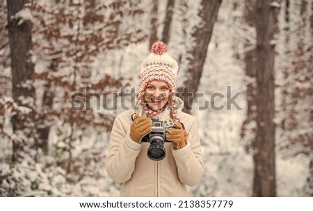 Winter hobby. Taking stunning winter photos. Enjoy beauty of snow scenery through photos. Woman photographer with professional camera. Enjoy enchanting paleness and freezing atmosphere of winter