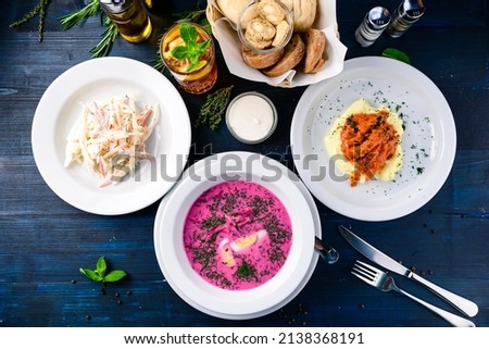 large lunch set of three courses soup, second course and salad, Top view of a three course set menu served on wooden table, business lunch set made of three meals Royalty-Free Stock Photo #2138368191