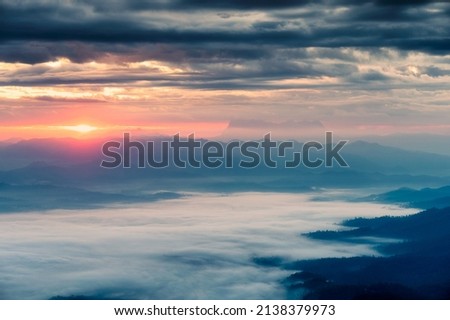 Beautiful sunrise over mountain with Doi Luang Chiang Dao peak and foggy in the valley at national park. Doi Dam, Wiang Haeng, Chiang Mai, Thailand