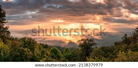 Panorama dramatic sunrise shining on mountain with foggy in the valley at national park. Doi Dam, Wiang Haeng, Chiang Mai, Thailand
