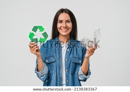 Young caucasian woman girl eco-activist holding recycling logo sign with plastic bottle for sorting garbage paper, environmental conservation saving planet from contamination, renewable energy sources