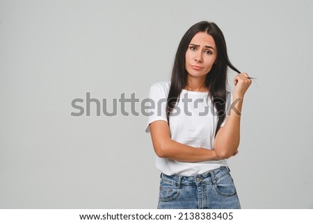 Sad offended caucasian young woman girl feeling frustrated blowing her lips, suffering from painful period, stomachache isolated in grey background.