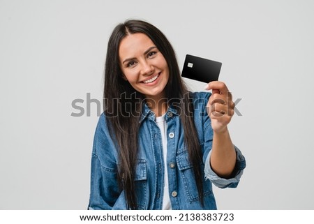 Happy caucasian young woman bank client customer showing credit card for online e-commerce transactions, cashback, loan, payment, debt shopping isolated in white background Royalty-Free Stock Photo #2138383723