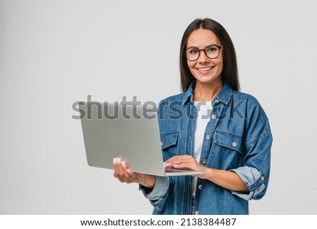 Young smiling caucasian student freelancer woman using laptop for remote work, e-learning at university college, e-banking, online shopping, webinars isolated in white background Royalty-Free Stock Photo #2138384487