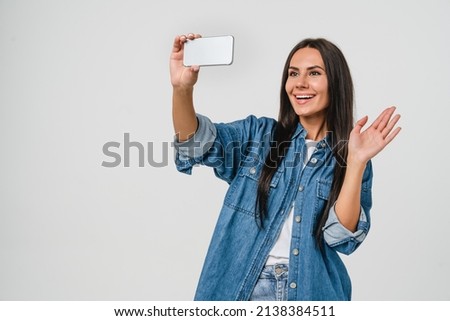 Videocall conversation meeting conference online. Caucasian young woman blogging vlogging taking selfie on cellphone for social media networks isolated in white background. Social distance