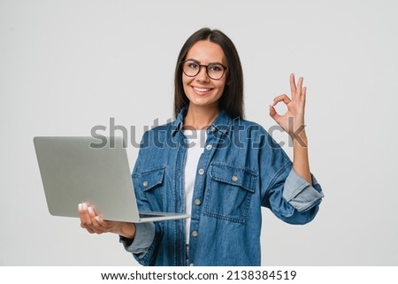Young smiling caucasian student freelancer woman using laptop for remote work, e-learning at university college, e-banking, online shopping, webinars showing okay gesture isolated in white background