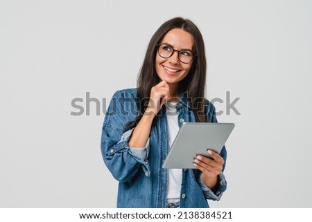 Pensive dreamy thoughtful caucasian young woman using digital tablet for distant work, freelance job, creative occupation, having idea startup isolated in white background Royalty-Free Stock Photo #2138384521