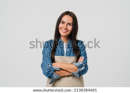 Young smiling caucasian female barista bar tender coffee maker woman in apron selling coffee hot beverage tea with arms crossed isolated in white background. Royalty-Free Stock Photo #2138384681