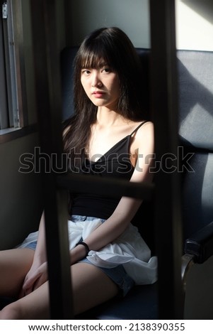 Portrait of thai japan adult beautiful girl black shirt blue jeans relax time, train station fashion