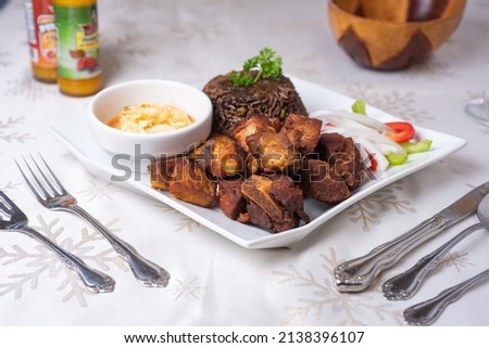 Fried Pork Haitian Food, Antilles Cuisine, Caribbean Dining, White tablecloth  Royalty-Free Stock Photo #2138396107